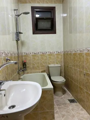 a bathroom with a tub and a toilet and a sink at Nile View Luxe Stay , Walk to Luxor Temple in Luxor