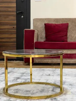 a gold and glass coffee table in front of a couch at Nile View Luxe Stay , Walk to Luxor Temple in Luxor
