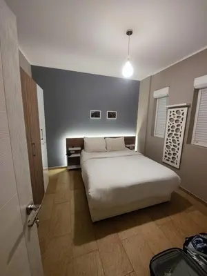 a bedroom with a large white bed in a room at Kite Lodging Hotel in Hurghada