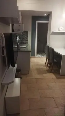a kitchen and dining room with a table and chairs at Kite Lodging Hotel in Hurghada