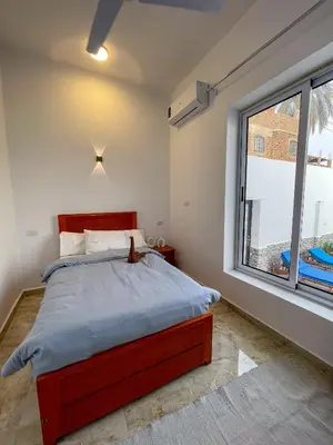 a bedroom with a bed and a large window at el rabia - private rooms in Luxor