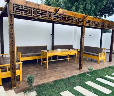 a wooden gazebo with benches and a table at el rabia - private rooms in Luxor