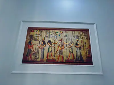 a painting in a white frame hanging on a wall at el rabia - private rooms in Luxor