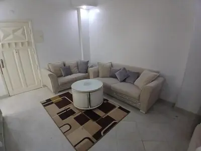 a living room with a couch and a table at Arrabia in front of Beirut Hotel in Hurghada