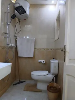 a bathroom with a toilet and a sink and a shower at Arrabia in front of Beirut Hotel in Hurghada