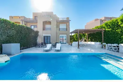 a swimming pool in front of a house at 4 Bdr Villa with private heated pool in Sabina in Hurghada