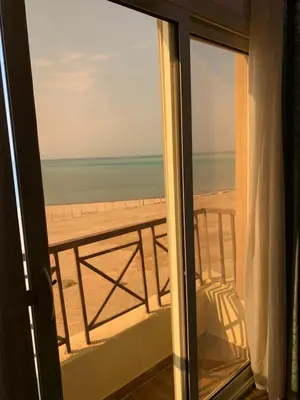 a view of the beach from a room with a window at casablanca resort in Hurghada