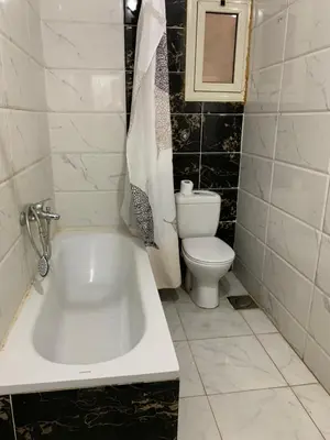 a bathroom with a white tub and a toilet at casablanca resort in Hurghada