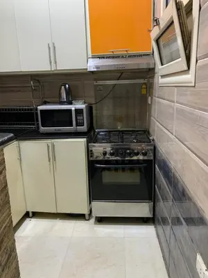 a small kitchen with a stove and a microwave at casablanca resort in Hurghada