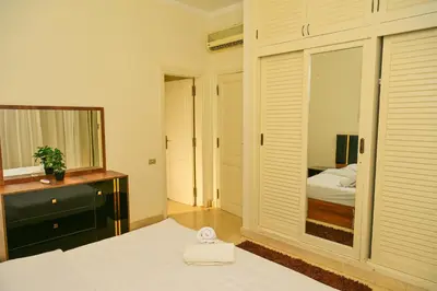 a bedroom with a mirror and a bed and a dresser at Breathtaking Villa in El Gouna 15 in Hurghada