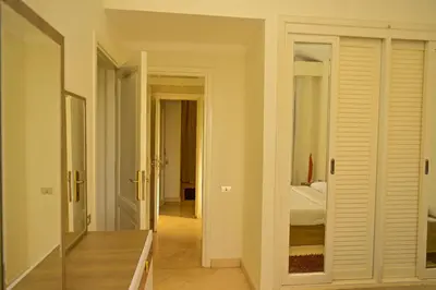 a room with a bedroom with a bed and a mirror at Breathtaking Villa in El Gouna 15 in Hurghada