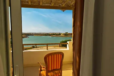 a chair on a balcony with a view of the water at Breathtaking Villa in El Gouna 15 in Hurghada