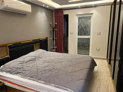 a bedroom with a bed and a window at Furnished apartment for rent in Abū Tīj