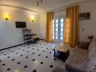 a living room with a couch and a tv at Rent Mubarak 2 in Hurghada