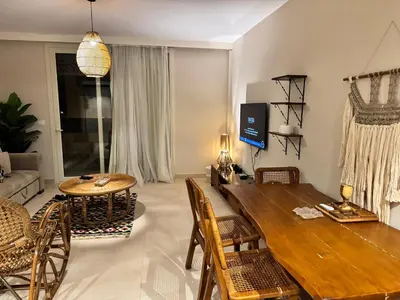 a living room with a wooden table and a dining room at M10-2b-04 mangrove in Hurghada