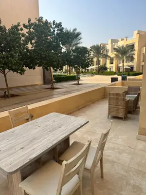 a wooden table and chairs on a patio at M10-2b-04 mangrove in Hurghada