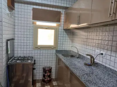 a small kitchen with a sink and a window at Apartment compound west sayed Al kawthar in Hurghada