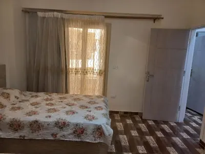 a bedroom with a bed and a window at Apartment compound west sayed Al kawthar in Hurghada