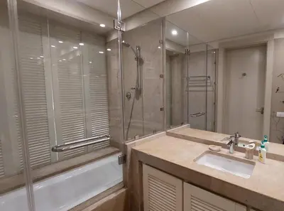 a bathroom with a shower and a sink and a tub at Scenic Cosy Nest - Infinity Pool - Ancient Sands in Hurghada