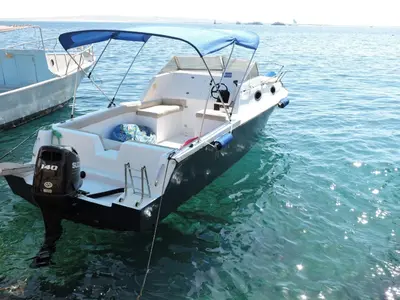 a white boat tied to a dock in the water at aladdin-travels-egy in Hurghada