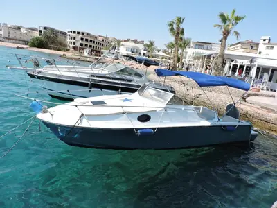 two boats are docked on the water in a harbor at aladdin-travels-egy in Hurghada
