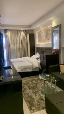 a hotel room with a bed and a living room at Cecelia Resort Hurghada H11 in Hurghada