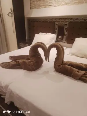 two towels shaped like hearts sitting on a bed at Cecelia Resort Hurghada H11 in Hurghada