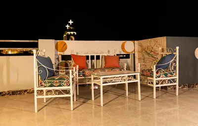 two chairs and a table on a balcony at night at Luxury Arabic Romantic Studio with its own large private Roof Terrace 15 mins from El Gouna in Hurghada