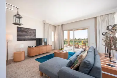 a living room with a blue couch and a television at Luxury Stays in Golf Town Houses in Hurghada
