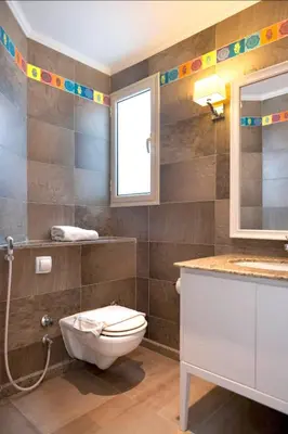 a bathroom with a toilet and a sink and a window at Luxury Stays in Golf Town Houses in Hurghada