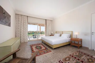a bedroom with a bed and a large window at Luxury Stays in Golf Town Houses in Hurghada