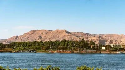 a large body of water with mountains in the background at Sun wing guest house in Luxor