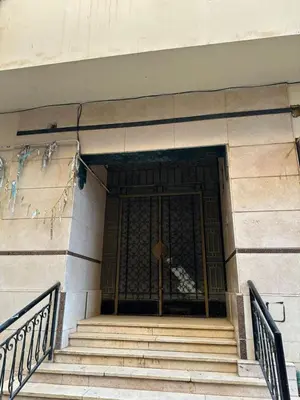 a set of stairs in a building with a gold door at شقة ايلا ترافيل in Luxor