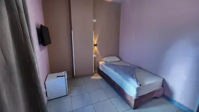 a small bedroom with a small bed in a room at Shapon Hotel - Hurghada in Hurghada