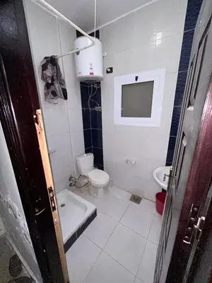 a bathroom with a tub and a toilet and a sink at cleopatra resort in Hurghada
