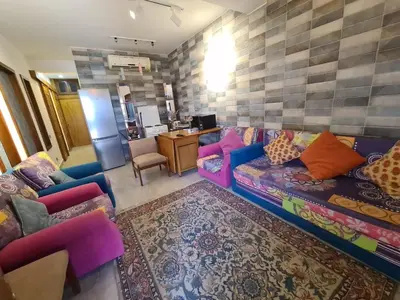 a living room with a couch and some chairs at ElGouna west golf 2 bedrooms 2 bathrooms - pool in Hurghada
