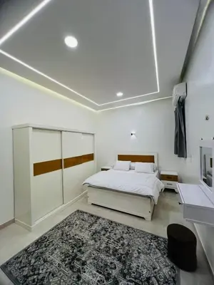 a white bedroom with a bed and a rug at Twins Villa Luxor in Luxor