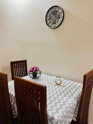 a dining room table with a clock on the wall at Azure horizon,Karma Aqua beach resort,Hurghada in Hurghada