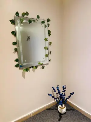 a mirror on a wall with plants on it at Azure horizon,Karma Aqua beach resort,Hurghada in Hurghada