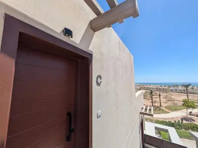 a door to a building with a view of the desert at Stunning Penthouse Seaview Apt in Mesca, Somabay in Hurghada