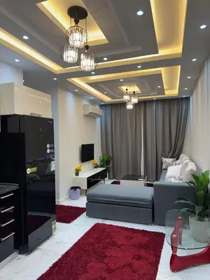 a living room with a couch and a tv at 1st Time Rental, 2 BDR Apartment, Pool View, Intercontinental District in Hurghada