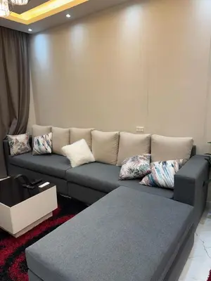 a couch in a living room with pillows on it at 1st Time Rental, 2 BDR Apartment, Pool View, Intercontinental District in Hurghada
