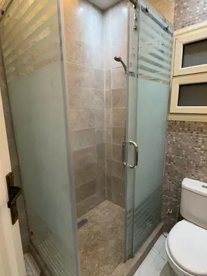 a shower with a glass door in a bathroom at 1st Time Rental, 2 BDR Apartment, Pool View, Intercontinental District in Hurghada