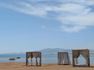 two chairs and a table on a beach at Panoramic Seaview Somabay 1BR Apartment in Mesca in Hurghada