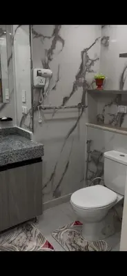 a bathroom with a white toilet and a sink at غرفه فندقيه in Hurghada