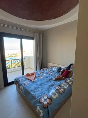 two children laying on a bed in a bedroom at 3 bedrooms penthouse with sea view in Hurghada