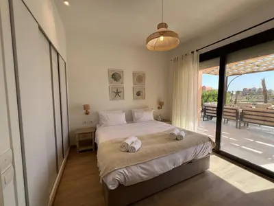 a bedroom with a large bed with towels on it at Gouna Ground-Floor Stylish 2Bdr in Hurghada