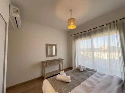 a bedroom with a bed with two towels on it at Gouna Ground-Floor Stylish 2Bdr in Hurghada