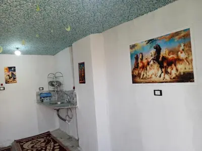 a room with a painting on the wall at Sun Rise House Luxor in Al Aqālitah