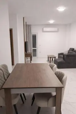 a living room with a wooden table and chairs at La prestigia Hurghada Apartment by Hurghada Concierge in Hurghada
